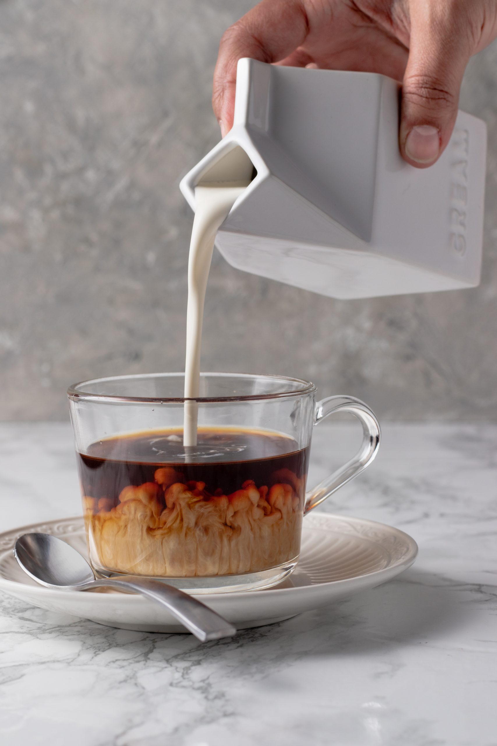 High Protein Dairy Coffee Creamer being poured iinto a glass coffee cup