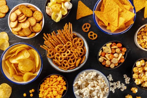 array of high protein snacks from pretzels, to popcorn, chips, and more